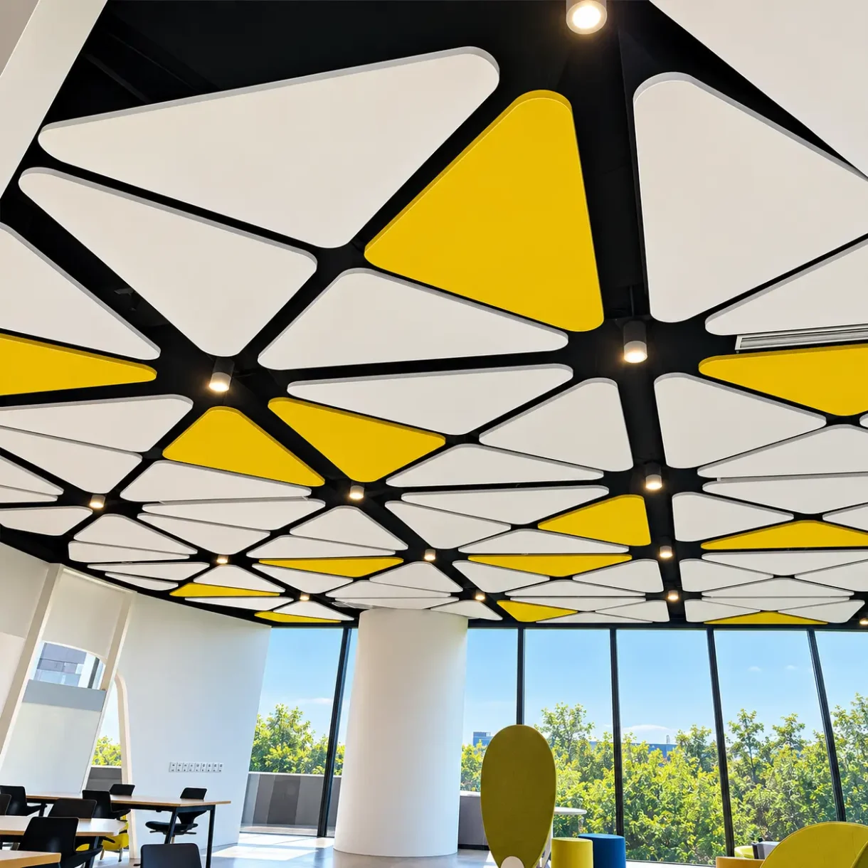 Custom triangular fiberglass acoustic ceiling panels in a geometric suspended ceiling design