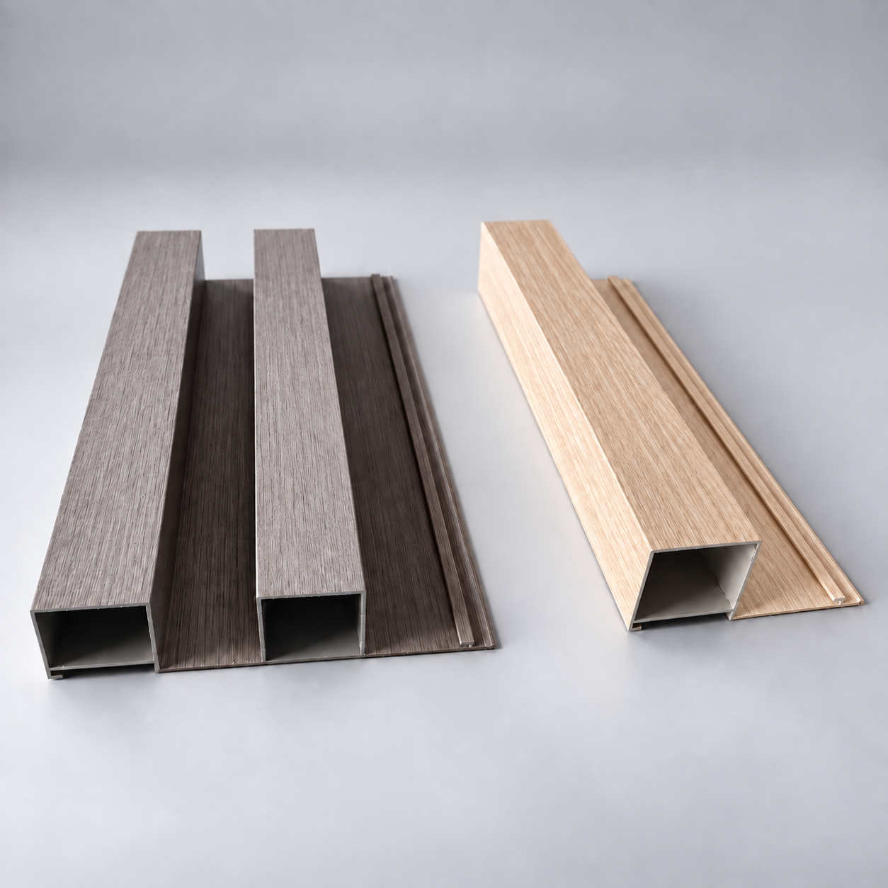 Close-up product samples of wood grain fluted aluminum wall panels, showing light and dark finishes with a hollow slatted structure.
