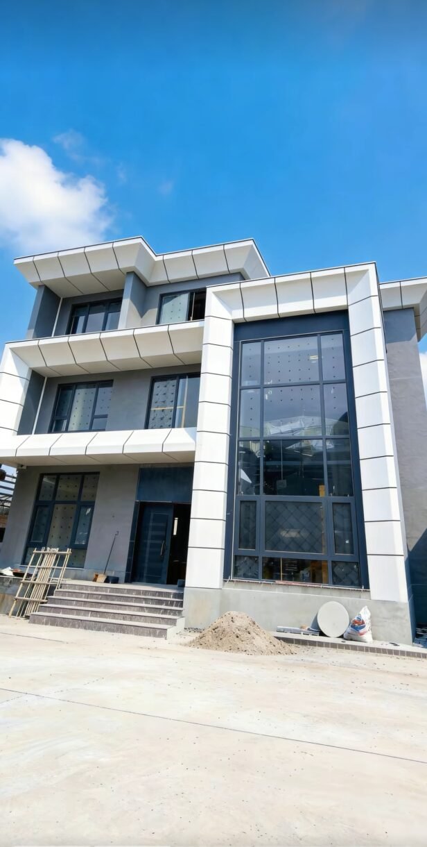 Gray aluminum veneer facade panels on a modern office building entrance