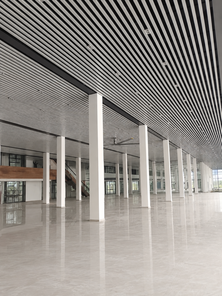 Black U shaped aluminum baffle ceiling in a commercial interior