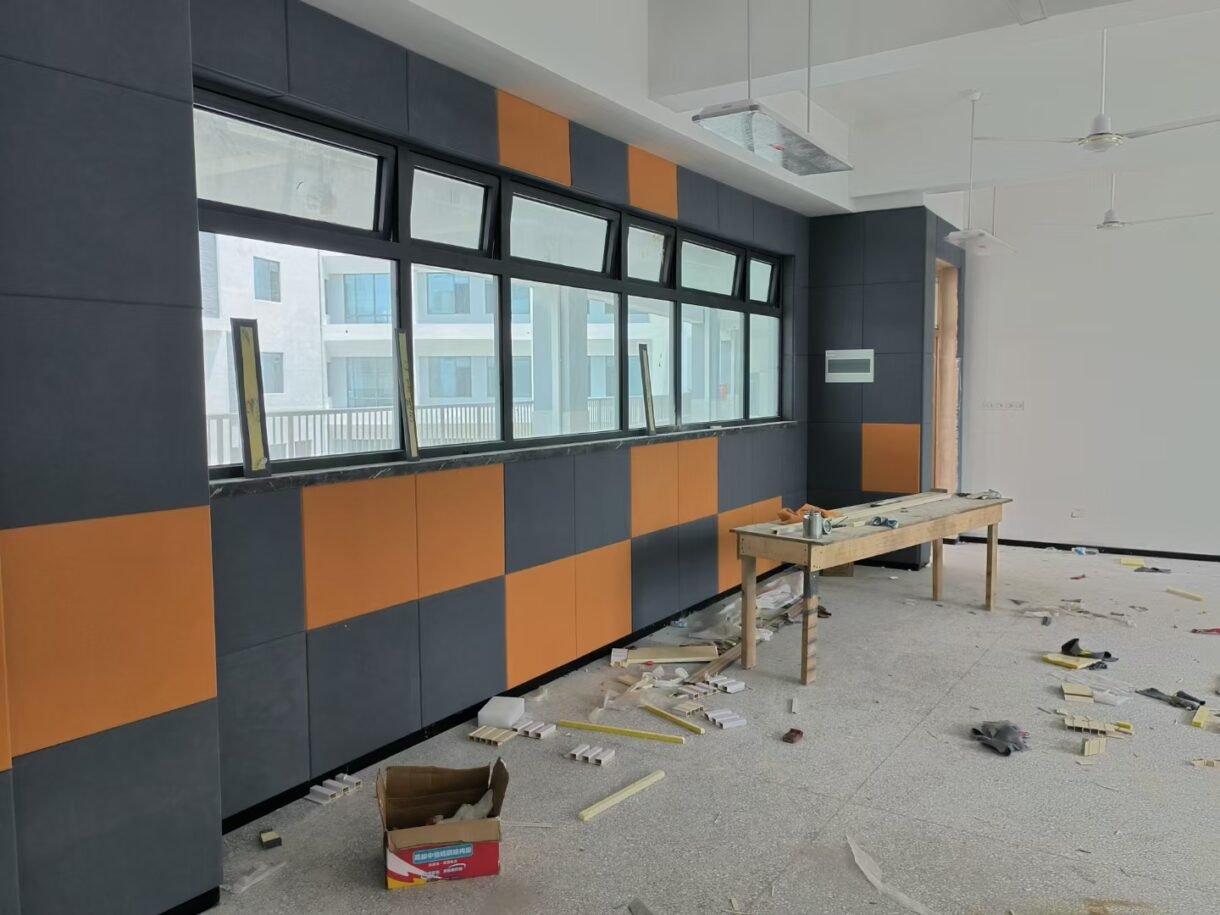 Installation of fabric-wrapped fiberglass acoustic panels for commercial wall sound absorption and acoustic design.