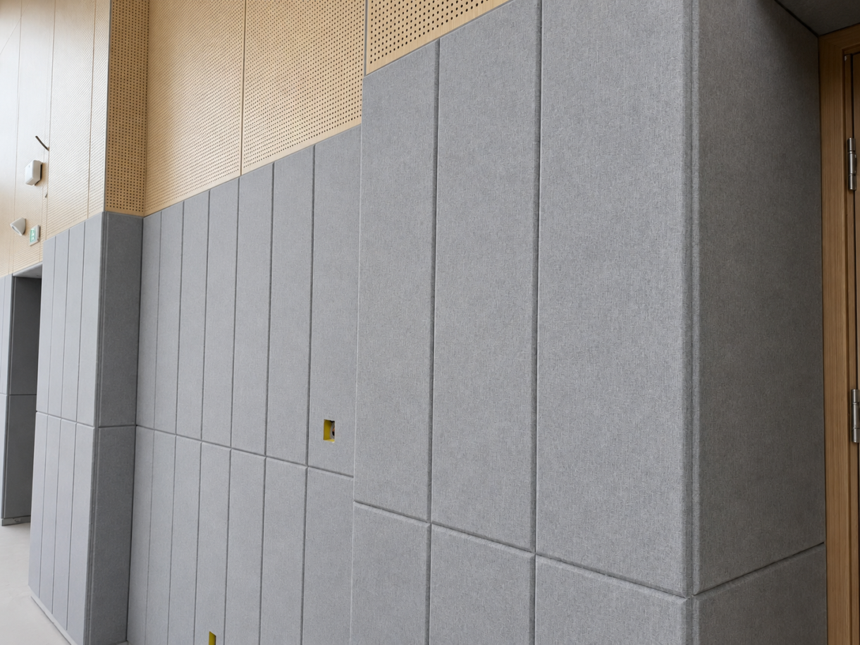 Gray fabric-wrapped fiberglass acoustic wall panels installed in an interior space
